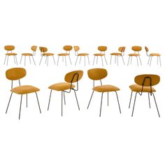 a set of eight chairs with black legs and yellow upholstered seats, all in different