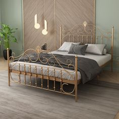 a bedroom with a metal bed frame and grey linens on the floor, along with green walls