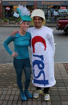 a man and woman dressed in costume posing for the camera with a sign that says pepsi on it