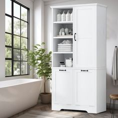 a bathroom with a white cabinet and tub