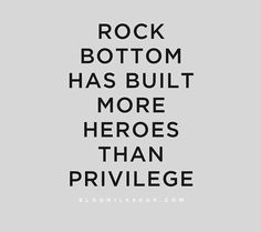 the words rock bottom has built more heroes than privelge on grey background with black and