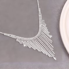 ✦ This Sparkly Zircon Tassel Waterfall Dinner Necklace exudes luxurious vibes and is the perfect accessory for any formal occasion, whether it be a dinner or a prom. The intricate tassel chandelier design, paired with the sparkling cubic zirconia stones, creates a stunning waterfall effect that will make you feel like a bling bling party queen. Pair it with your favorite gown for a grand and enchanting look. ----------- DETAILS ----------- - Color: Silver - Materials: Alloy, Cubic Zirconia - Nec Dinner Necklace, Bling Bling Party, Gothic Minimalist, Tassel Chandelier, Bling Party, Party Queen, Elegant Gothic, Crystal Hoop Earrings, Nose Rings Hoop