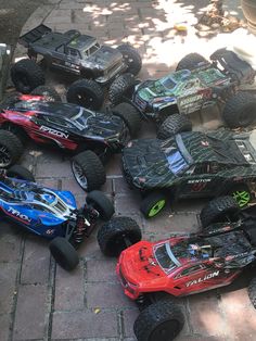 several remote controlled cars are lined up on the ground