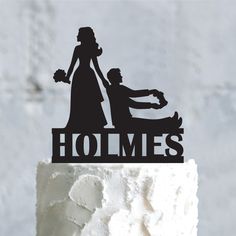 a wedding cake topper with the silhouette of a bride and groom in a carriage