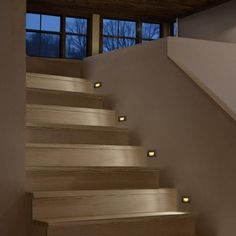 the stairs are made of wood and have lights on them