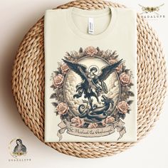 Introducing our Vintage St. Michael The Archangel Tee 🙏👕 Embrace timeless style and faith with our unique design! Perfect for Catholic Christians seeking meaningful gifts and fashion statements. Wear your devotion proudly. #StMichael #CatholicFashion #GuadalupeClothing Prayer: St. Michael the Archangel, defend us in battle. Be our protection against the wickedness and snares of the devil. May God rebuke him, we humbly pray, and do thou, O Prince of the heavenly hosts, by the power of God, thru Catholic Fashion, St Michael The Archangel, Vintage Boho Style, Michael The Archangel, Vintage Boho Fashion, Catholic Art