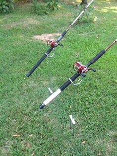 two fishing rods are sitting on the grass