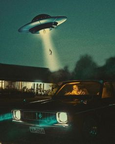 an old car with a flying object in the sky above it and a man sitting inside