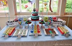 a blue table topped with lots of desserts