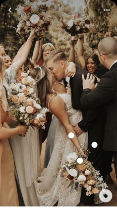 a group of people standing around each other holding flowers