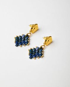 Handmade Miyuki Half-Tila Earrings - Lapis Lazuli By The Gem Stories Add a touch of elegance to your style with the Miyuki Half-Tila Earrings - Lapis Lazuli. Handwoven with premium Miyuki Half-Tila beads in a striking lapis lazuli color, these earrings offer a unique and luxurious design. The Duracoat Galvanized Yellow Gold rocailles add a beautiful contrast to the deep blue beads, while the 24k gold-plated elements and 925 sterling silver ear nuts provide a secure and comfortable fit. Perfect f Tila Earrings, Tila Beads, Miyuki Beads, Luxurious Design, Blue Beads, Sterling Silber, Lapis Lazuli, Silver Color, Jewelry Earrings Dangle