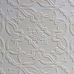 an intricate white wallpaper with decorative designs on it's side and the bottom