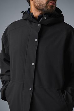 Stay dry without compromising style in this coat. It's stacked with functional features like a tall collar, a hood with bungees, zippered side pockets, and a secure zipper-and-snap front. Plus, it's made from soft, lightweight, 100 percent waterproof ripstop with a relaxed fit to accommodate movement. Cool on the streets? Yes. Suitable for stormy days? Also yes. Alo Yoga Hooded Outerwear With Drawstring, Alo Yoga Hooded Outerwear For Winter, Alo Yoga Fall Outerwear With Drawstring Hood, Alo Yoga Drawstring Hood Outerwear For Fall, Alo Yoga Outerwear With Drawstring Hood For Fall, Sporty Hooded Alo Yoga Outerwear, Functional Hooded Outerwear For Work, Functional Outerwear With Detachable Hood For Work, Urban Outerwear With Detachable Hood For Work