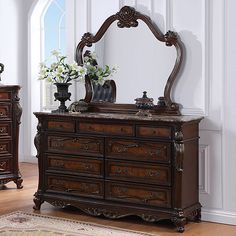 an ornate dresser and mirror in a room