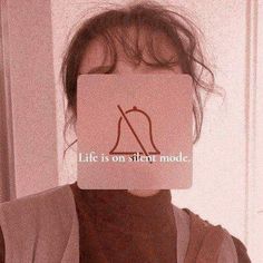 a woman holding up a card with the words life is on silent mode in front of her face