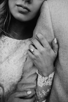 a black and white photo of a woman wearing a ring