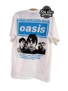 OK guys, this is an oasis T shirt and it's single stitched. It's a short sleeve crewneck and it's on 100% white cotton super soft and comfortable to wear. The front is hand silkscreened with the Oasis logo and a light blue color and below that it says "Definitely Maybe Tour 94" on the back of the shirt again is the Oasis logo and above the logo it says "Definitely Maybe Your '94". Below the logo it has a black-and-white image of the band and below the band in light blue are the cities listed in Oasis Definitely Maybe, Oasis Logo, Definitely Maybe, The Oasis, Anime Tees, Movie Tees, Summer Tour, White Image, Light Blue Color