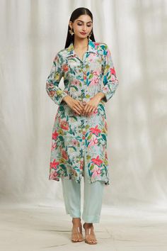 Blue oversized shirt style kurta with garden print and spread collared neckline. Paired with pant.
Components: 2
Pattern: Printed
Type Of Work: Garden
Neckline: Spread collar
Sleeve Type: Full sleeves
Fabric: Kurta: Crepe, Pant: Modal Satin
Color: Blue
Other Details: 
Front button detailing
Occasion: Work - Aza Fashions Blue Tunic Sets For Spring, Blue Straight Kurta Tunic For Spring, Floral Print Straight Kurta Blouse For Spring, Spring Floral Print Straight Kurta Blouse, Spring Blue Floral Print Kurta, Blue Kurta With Printed Motifs For Spring, Straight Kurta With Set-in Sleeves For Spring, Spring Straight Kurta Blouse With Printed Motifs, Summer Workwear Kurta With Long Sleeves