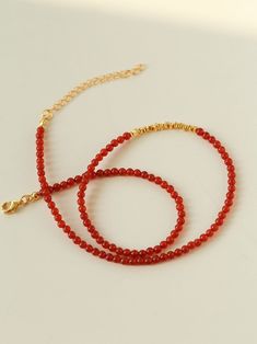 How can the New Year be complete without it? Introducing our Red Agate Beaded Necklace with scattered gold accents – the perfect accessory to enhance your complexion and add a radiant touch! Featuring delicate 3mm natural agate beads, this necklace is both versatile and sophisticated. The subtle gold elements effortlessly elevate its charm, ensuring a stylish yet timeless appeal.Scattered gold accents add a touch of luxury, making it a versatile piece that transcends trends.This high-end necklace is a must-have for the festive season, pairing seamlessly with light-colored sweaters for an absolutely stunning look. Its exquisite craftsmanship and festive vibes make it the ideal accessory to elevate your style and capture the holiday spirit. Don't miss out on this chic and sophisticated neckl Red Agate Beaded Necklaces With Round Beads, Red Agate Beaded Necklace With Gemstone Beads, Elegant Gold Carnelian Beaded Necklaces, Elegant Gold Carnelian Beaded Necklace, Red Beaded Agate Necklaces, Gold Beaded Necklaces With Red Coral, Red Carnelian Beaded Necklace With Faceted Beads, Red Carnelian Faceted Beaded Necklaces, Elegant Carnelian Beaded Necklace With Gemstone Beads