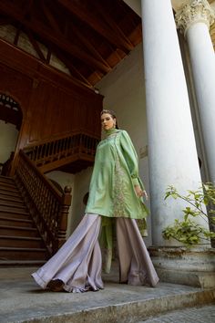 DETAILS Boat neck shirt with a buttoned, side pleat, delicately hand embroidered. Exaggerated balloon sleeves, pleated cuffs, and embellished ties. Paired with a contrasting gharara, pleated edge. Organza dupatta with embroidered motifs and embroidered panels. COLOR Green / Grey SIZE Custom Order - A measurement guide will be sent upon order. Model is 5'7 MATERIAL Shirt - Silk Katan Self JamawarGharara - Raw SilkDupatta - Khaddi Spun Silk Net / Silk Organza PRODUCT CODE 300000-08-28 PRODUCT OF P Wedding Sets With Embroidered Cuffs Long Sleeve, Elegant Long Sleeve Sets With Embroidered Cuffs, Spring Kurta With Embroidered Cuffs And Long Sleeves, Spring Long Sleeve Kurta With Embroidered Cuffs, Elegant Kurta With Embroidered Cuffs For Eid, Eid Long Sleeve Sets With Embroidered Cuffs, Elegant Green Kurta With Embroidered Sleeves, Silk Sets With Embroidered Sleeves And Long Sleeve, Silk Long Sleeve Blouse For Eid