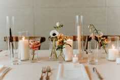 the table is set with candles and flowers