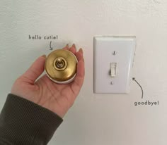 a hand holding a light switch in front of a white wall with instructions on how to wire it