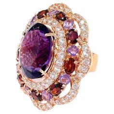 Bochic "Flamenco” Amethyst & Fancy Multi Gems Cocktail Ring 18K Gold & Silver Cluster Multi Color Fancy Gems from Sri Lanka Purple Amethyst - 9 Carat White Topaz - 2 Carat Red Garnet - 3 Carat This Ring is from the "Flamenco” traveling collection are the epitome of elegance and versatility. It offers a perfect blend of day to night and swimwear to evening wear, allowing you to effortlessly transition between different occasions and outfits. Wearing these spectacular oriental-style ring will undo Multi Gem Ring, Fancy Sapphire, Tree Jewelry, Tanzanite Diamond Ring, Garnet And Gold, Topaz Color, Gold Cocktail Ring, Gold Cocktail, Jewelry Tree