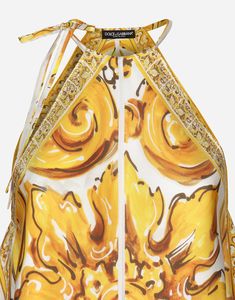 Silk twill halterneck top with majolica print: White and Yellow Halterneck with ties Sleeveless Lined in twill Tie details on sides The model is 175 cm tall and wears a size IT 40 Made in Italy Designer Printed Tops For Summer, Designer Printed Summer Tops, Luxury Silk Tops For Summer, Luxury Sleeveless Summer Tops, Yellow Silk Top With Floral Print, Yellow Floral Print Silk Tops, Designer Yellow Summer Tops, Luxury Floral Print Summer Tops, Summer Silk Tie Back Tops