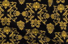 a black and gold wallpaper with an ornate design