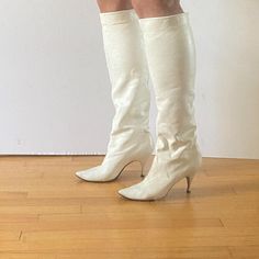 Beautiful and rare vintage 1960s Joseph white leather tall boots with little kitten stiletto heels and pointed toes. Like a very sophisticated gogo boot. The leather is so soft that it's almost stretchy, maybe kid skin (?) and these can be worn pulled to the knee or slouched down. Leather soles. Boots have some general markings and discoloration to the white leather as shown and scuffing mostly at the backs and heels. Approx 9.75" along insole from toe to heel, 2 7/8" across ball of foot, 3.25" heel height. Cream Pointed Toe Fitted Boots, Fitted Cream Boots With Pointed Toe, Fitted Cream Pointed Toe Boots, Cream Colored Fitted Heeled Boots With Pointed Toe, Fitted Cream Knee-high Heeled Boots, Cream Fitted Boots For Party, Fitted Cream Heeled Boots For Party, Fitted Cream Boots For Party, Vintage High Heel Boots For Party