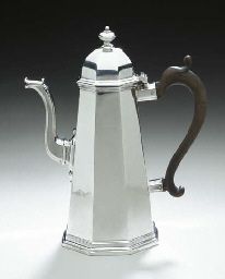 a silver coffee pot sitting on top of a white countertop next to a black handle