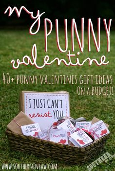 a basket filled with valentine's day candy on top of a grass covered field