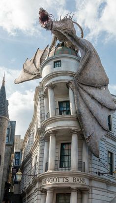 a statue of a dragon on top of a building