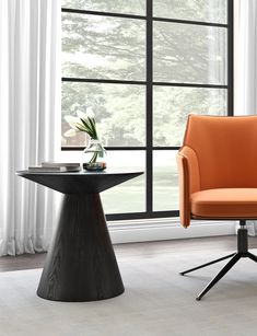 an orange office chair sitting next to a black table in front of a large window