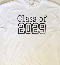 a white t - shirt with the words class of 2099 printed in black on it