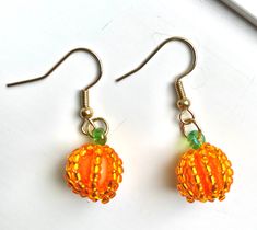 Seed bead baby pumpkin earrings are ready for fall! Show your love for fall or Halloween wearing these little cuties! Handmade with gold plated wire and Czech beads. Handmade Gold Halloween Earrings, Handmade Gold Earrings For Halloween, Beaded Pumpkin Earrings, Beaded Pumpkin, Baby Pumpkin, Pumpkin Earrings, Thread Painting, Ready For Fall, Blue Gift