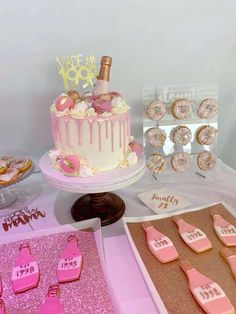 a table topped with lots of pink and white desserts