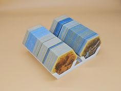 three stacks of blue and yellow playing cards on a brown surface with the image of a lion