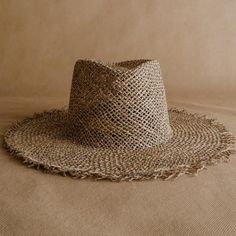 Discover the Acapulco hat: a new frayed straw hat handmade in México from seagrass. Shine at your holiday destination with this light and airy hat. The frayed edge and diamond shape of the crown give it a boho-chic touch. The elastic band on the inside provides strength and wearing comfort. Handcrafted in Mexico Ethically made from natural material Support artisanal communities Brand Partnership with Sandoval. Spring Beach Hat With Open Weave, Bohemian Open Weave Sun Hat For Vacation, Woven Natural Fiber Straw Hat For The Beach, Straw Hat With Open Weave For Beach, Straw Hat With Open Weave For The Beach, Coastal Handwoven Summer Hat, Open Weave Summer Beach Hats, Woven Jute Straw Hat For Beach Season, Wide Brim Straw Hat With Open Weave For Vacation