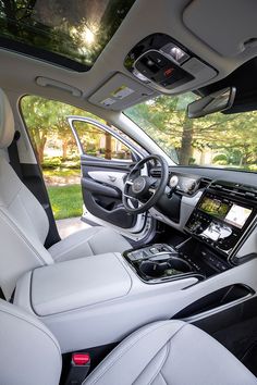 the interior of a car with white leather and black trims, including dash lights