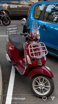 a red scooter parked next to a blue car