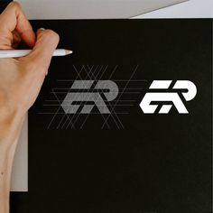 a person writing on a piece of paper with a pen in their left hand and the logo for an electronic company