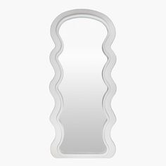 a white mirror with wavy shapes on it's sides and an oval shaped frame