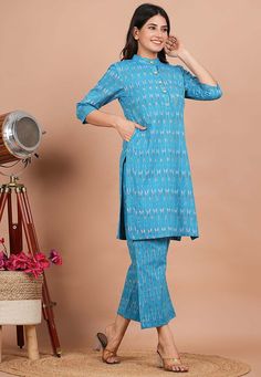 Readymade Cotton Straight Kurta in Sky BlueThis attire is Enhanced with Buttons and Ikat Printed . Crafted in Chinese Collar and Quarter SleeveAvailable with a Cotton Palazzo in Sky Blue along with PocketsDo note: Accessories shown in the image are for presentation purposes only and length may vary upto 2 inches.(Slight variation in actual color vs. image is possible).    We sell all kinds of women's and ladies tops Casual Kurtas |Indian Tops |Gowns |Ladies Dresses |Indian Fashionable Tops |Indi Blue Straight Kurta Sets For Summer, Blue Ikat Print Straight Kurta Set, Blue Cotton Ikat Print Sets, Blue Cotton Sets With Ikat Print, Festive Blue Ikat Print Kurta, Chinese Collar Kurti, Kurtis Indian, Collar Kurti, Indian Tops