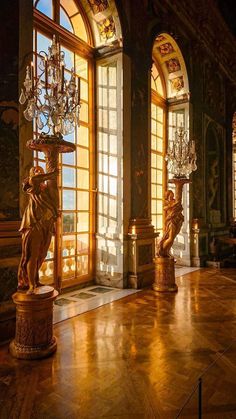 an ornate room with chandeliers and windows