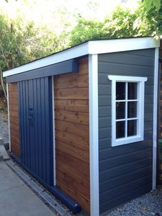 a small shed with a door and windows