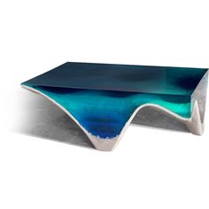 a table that has some blue and green paint on it, with a white base