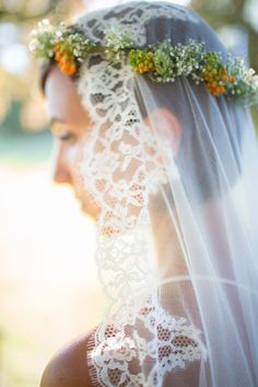 a woman wearing a veil and flowers in her hair