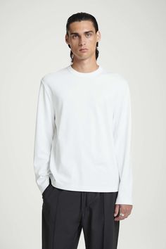 This black long-sleeved T-shirt is made from interlock organic cotton, a double-layered knitted jersey that's soft, durable and warm. It's cut in a relaxed shape and has a classic crew neck. Relaxed fitOrganic cotton is grown from non-genetically modified seeds without chemical fertilizers or pesticides Shell: 100% Organic cotton. Trims: 100% Cotton. Excluding trims / Machine wash Back length of size M is 25.70" / Model wears a size M Belted Cape, Women Magazines, Cardigan Shirt, Genetically Modified, Pesticides, T Shirt Vest, White Long Sleeve, Black Long Sleeve, Jumpsuit Dress