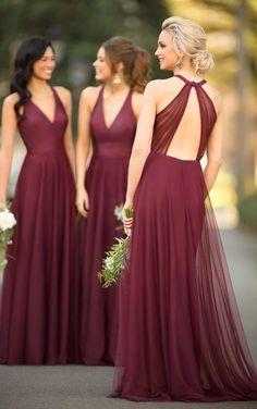 the bridesmaids are looking at each other in their maroon gowns and dresses